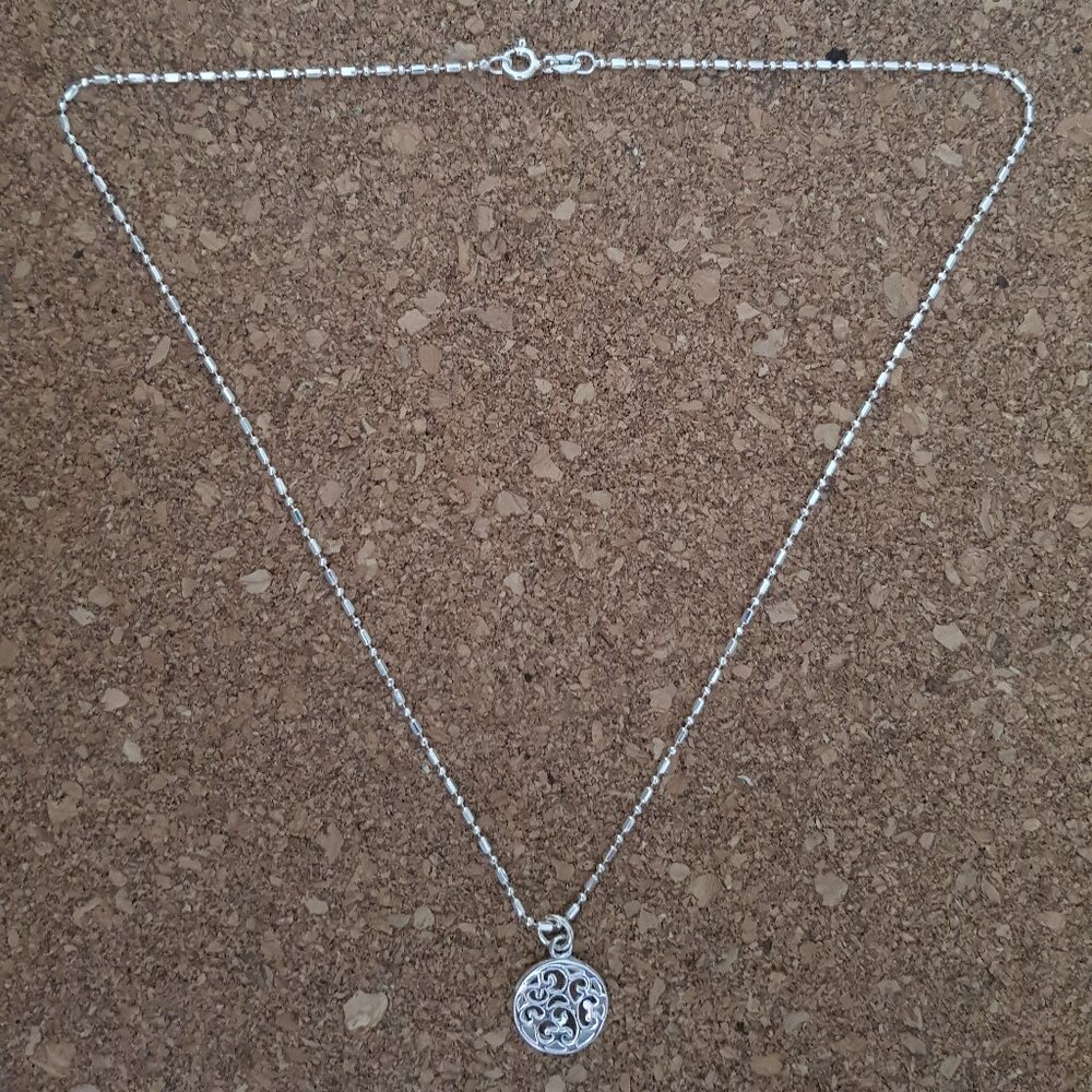 Sterling silver necklace with round filigree pendant